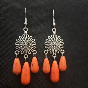 Antique silver starburst and orange dyed howlite teardrop chandelier earrings